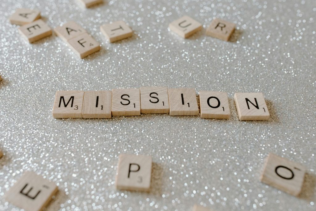 pexels-photo-7666429-7666429 Scrabble tiles spelling 'Mission' on a sparkling surface convey determination and goals.